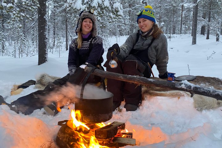a couple of people that are sitting in the snow