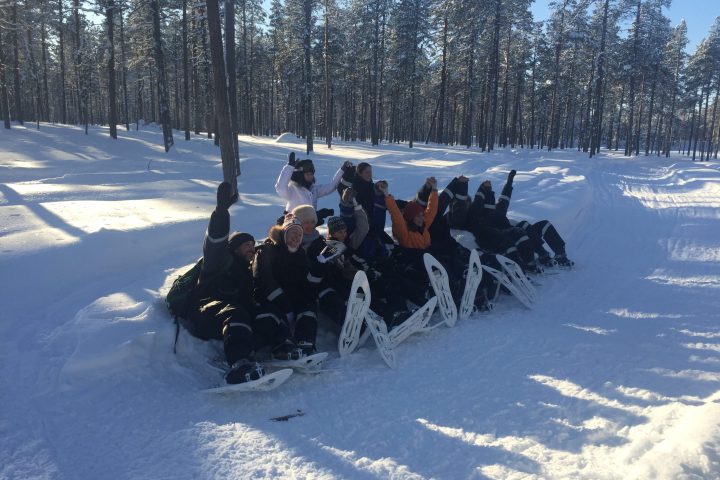 a group of people on a trail in the snow