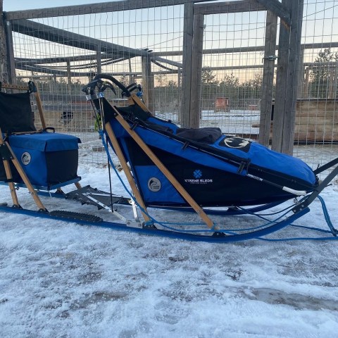 a blue and white boat parked next to a body of water